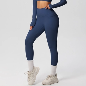 Detail view of high-waist navy yoga pants featuring side pockets and breathable fabric