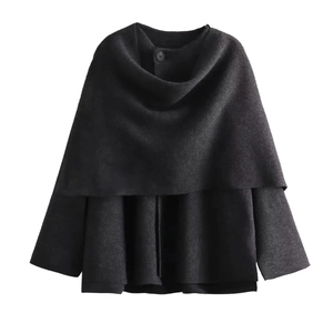 Detail of black knit shawl coat with a single button and layered wool texture design