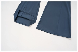 Detail view of flared yoga pants cuffs featuring professional double-needle stitching