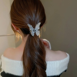 Exquisite butterfly hair claw clip with zircon stones shown on a woman hairstyle