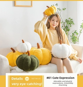 Detail of plush pumpkin pillows in white, yellow, and green with soft sherpa texture