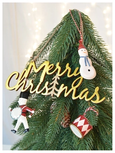 Detailed view of Merry Christmas gold lettering and nutcracker on a festive pine tree