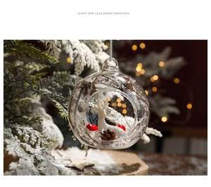 Detail of clear Christmas ball featuring a white reindeer, red mushroom, and faux snow