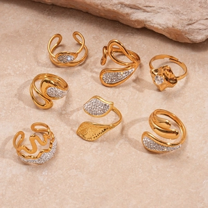 7-piece gold stainless steel ring set with geometric leaf shapes and zircon accents
