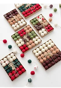 Detailed set of Christmas wool felt balls in kraft paper boxes with snowflake patterns