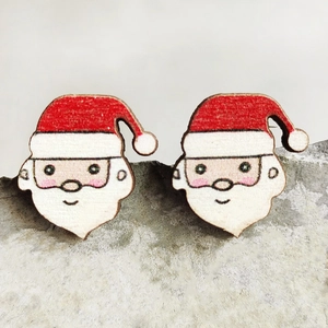 Detailed close-up of Santa Claus wooden stud earrings displayed on a grey stone texture