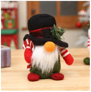 Close-up of Christmas gnome ornament with plaid hat and striped candy cane accessory