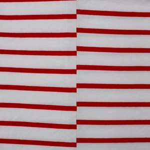 Close-up of red and white striped cotton fabric with detailed double stitching seams