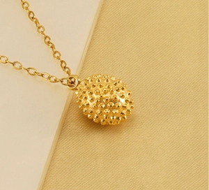 Close-up of a 18k gold-plated stainless steel durian-inspired textured pendant necklace