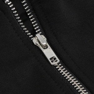 Close-up of a premium silver metal zipper on a black fabric fashion garment piece