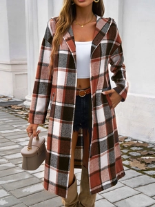 Detailed view of women's hooded plaid coat with contrasting buttons and side pockets