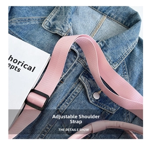 Detail shot of the adjustable pink shoulder strap with durable buckle on gym bag