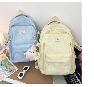 Close-up of bubble textured fabric school backpack with cute rabbit charm and side pocket