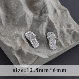 Macro shot of silver flip-flop earrings set with clear cubic zirconia crystals, 12.8mm size