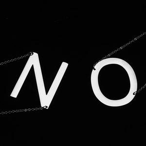 Polished titanium steel initial necklaces featuring letters N and O on black background