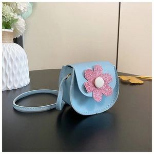 Detail of light blue girls' mini purse with pink sequin flower and slim shoulder strap