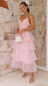 Detailed view of layered pink organza tiers and pleated texture on backless evening dress