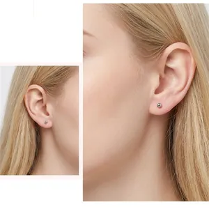 Minimalist S999 sterling silver ball stud earrings for daily wear on female model