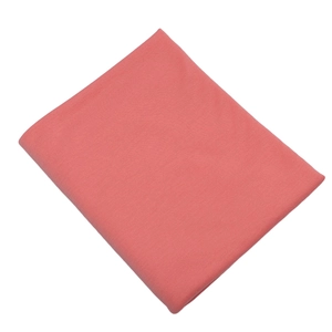 Detail showing the texture and soft drape of the folded pink mercerized cotton jersey fabric