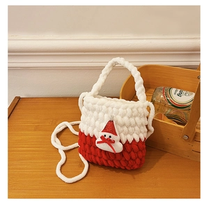 Detail of red and white handmade crochet bag with a cute 3D Santa Claus figure