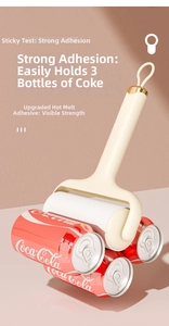 Macro detail showing strong adhesive lint roller lifting three soda cans by hot melt glue