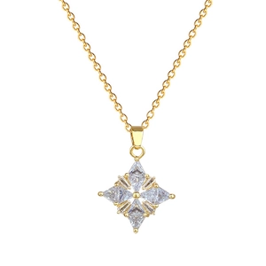 Elegant gold four-leaf clover pendant necklace with white zircon on white background