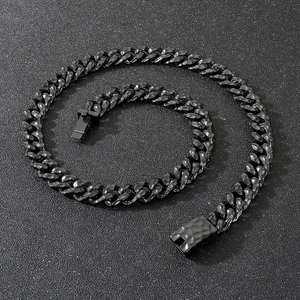 Detailed view of black hammered cuban chain necklace with textured metal surface