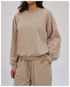 Detail of premium beige knit loungewear set with ribbed cuffs and loose casual fit