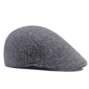 Detailed close-up of grey herringbone winter flat cap showing the fine fabric texture