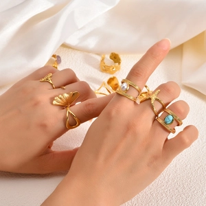 Detail of 18k gold plated stainless steel rings featuring seahorse and bohemian motifs