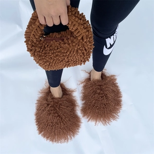 Detailed close-up of brown plush handbag and matching slippers in a lifestyle setting