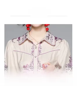 Macro detail of the vintage floral shirt collar with purple piping and small metal buttons