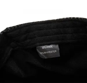 Detail shot of care label showing 30% wool and 70% polyester fabric material composition