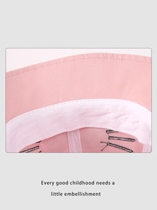 Detailed close-up of pink bucket hat featuring white inner lining and cat whisker embroidery