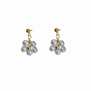Elegant gold flower stud earrings with natural freshwater pearls on a white background