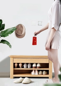Strong adhesive brushed gold wall hook holding a hat and bag in a home entryway