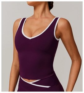 Detail of V-neck dark purple sports top with white contrast piping and high-stretch fabric