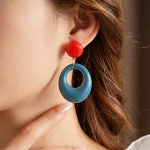 Retro geometric resin earrings in red and peacock blue with minimalist large circle design