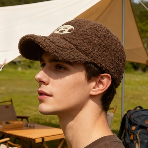 Brown fleece baseball cap with letter A embroidery in an outdoor camping setting