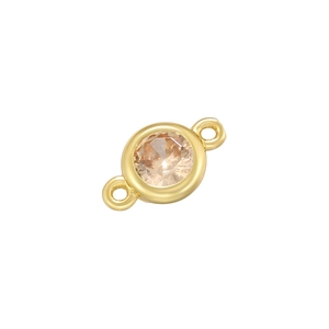 Close-up of golden round connector with champagne zircon for DIY jewelry making