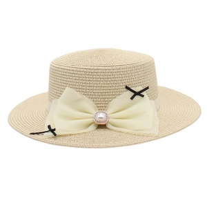 Detailed close-up of straw boater hat featuring a large gauze bow with pearl and rhinestone detail
