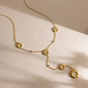Détail du collier en Y plaqué or 18K avec cinq délicats pendentifs marguerites en zircon