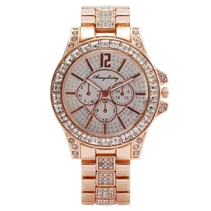 Macro detail of rose gold watch dial with rhinestone accents and chronograph sub-dials