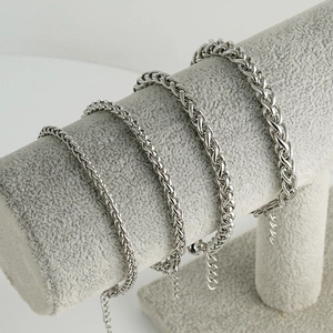 Retro stainless steel dragon bone chain bracelets in four widths on jewelry display