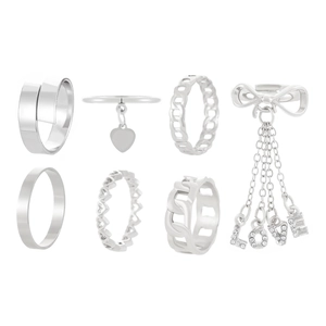 Close-up of 7-piece silver ring set featuring heart charms, chains, and love pendants