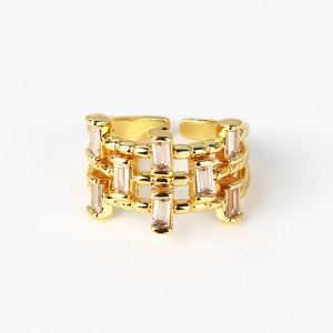 Detail of adjustable gold ring with hollow mesh design and rectangular zircon stones