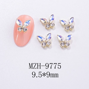 Macro view of 9.5x9mm butterfly nail charms with colorful rhinestones on pink nail
