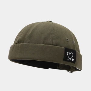 Detail of olive green miki hat canvas texture with heart patch and metal eyelets