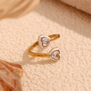 Close-up of 18K gold-plated double heart ring with white enamel and sparkling zircon stones