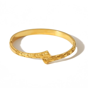 18K gold plated stainless steel bangle with geometric relief patterns on a white background